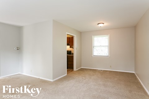 a master bedroom with carpet and a door to the bathroom