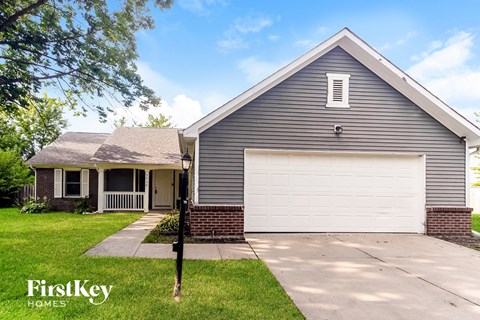 A house with a garage door is for sale by FirstKey Homes.