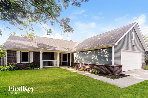 A house with a garage and a well-kept lawn.