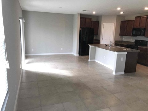 an empty kitchen and living room in a house