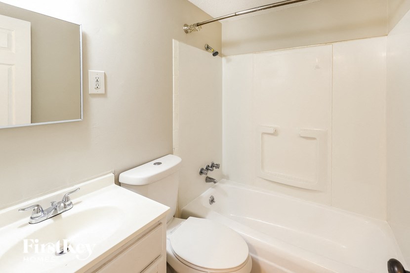 a white bathroom with a sink toilet and tub
