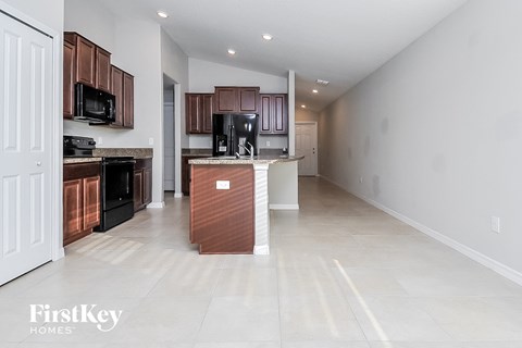A kitchen with brown cabinets and a white door.