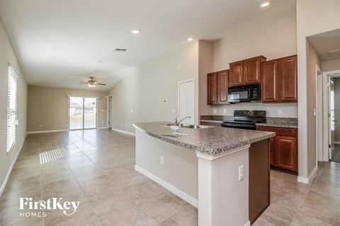 A kitchen with a counter top and a microwave.