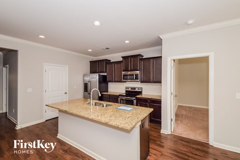 A kitchen with a granite countertop and a sink.