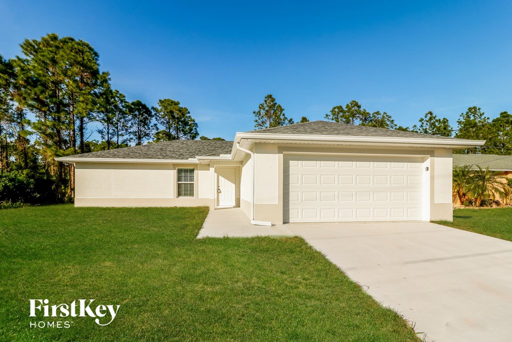A white house with a garage is shown in the image.
