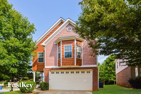 a pink house with a white garage door