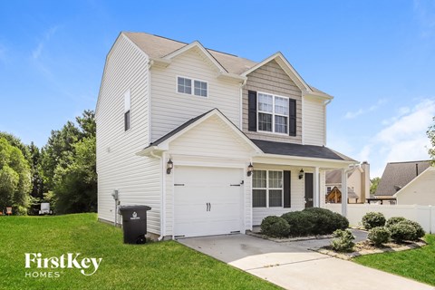 a white house with a garage and a driveway