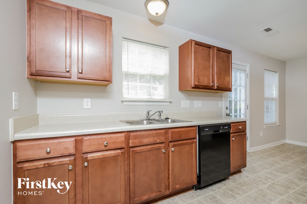 a kitchen with wooden cabinets and a sink and a window