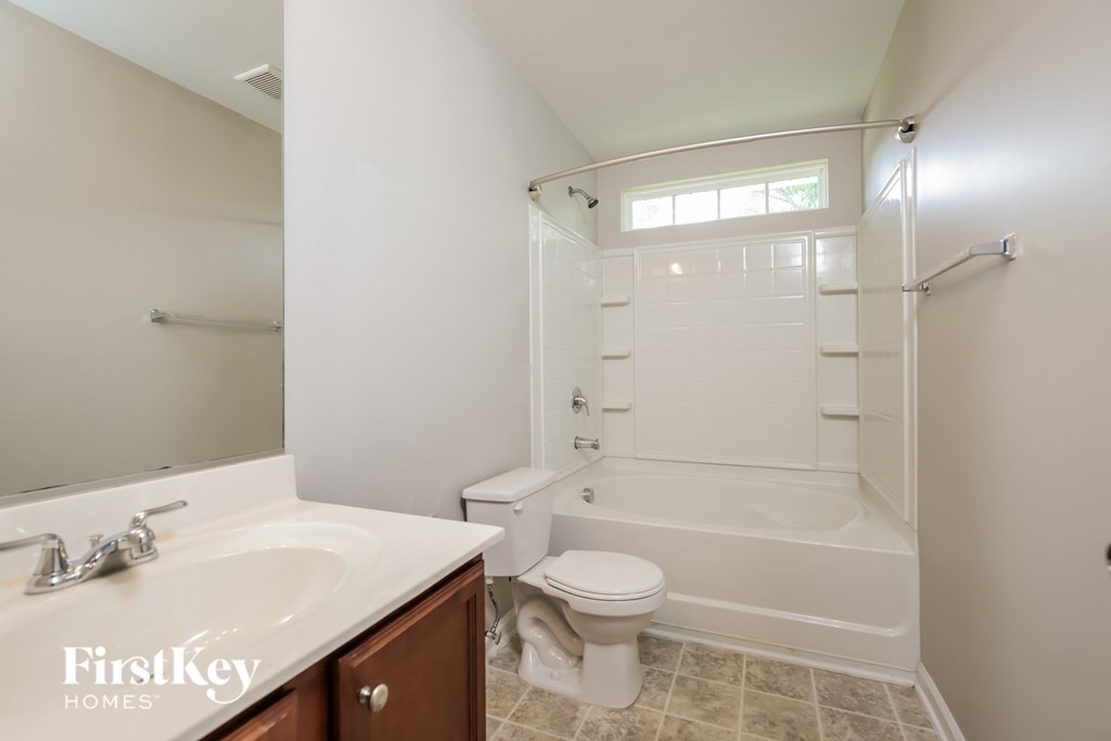 a small bathroom with a shower toilet and sink
