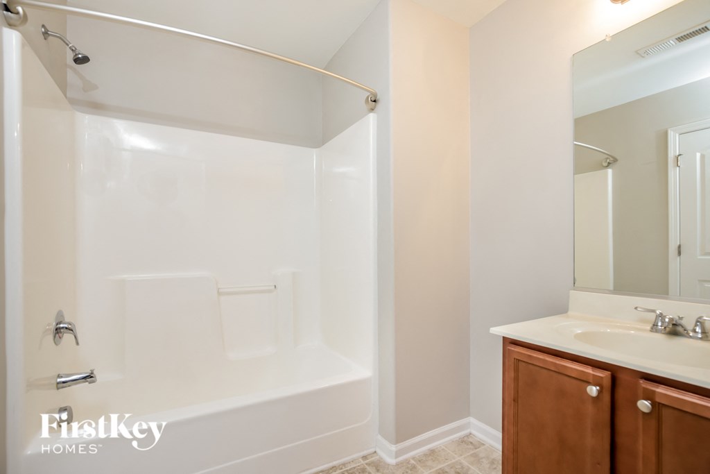 a small bathroom with a shower and a sink