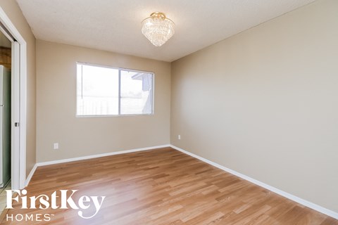 a living room with wood floors and a window