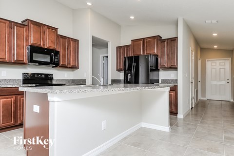 a kitchen with wooden cabinets and a granite counter top
