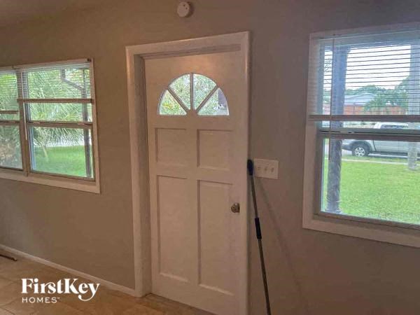 a white door in a room with a window