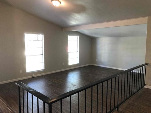 a view of a living room from the top of a staircase