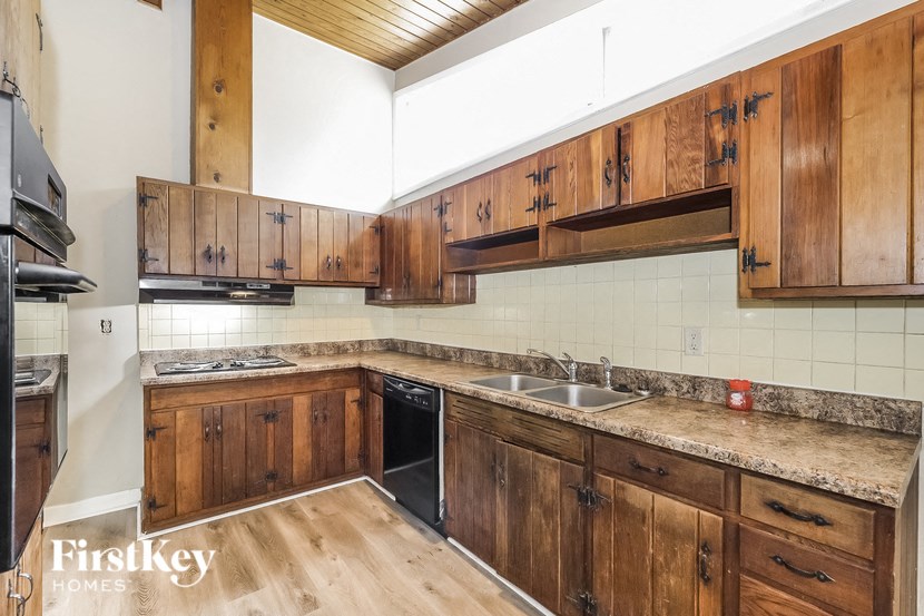a kitchen with wooden cabinets and a sink