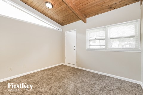 the living room of a home with carpet and a window