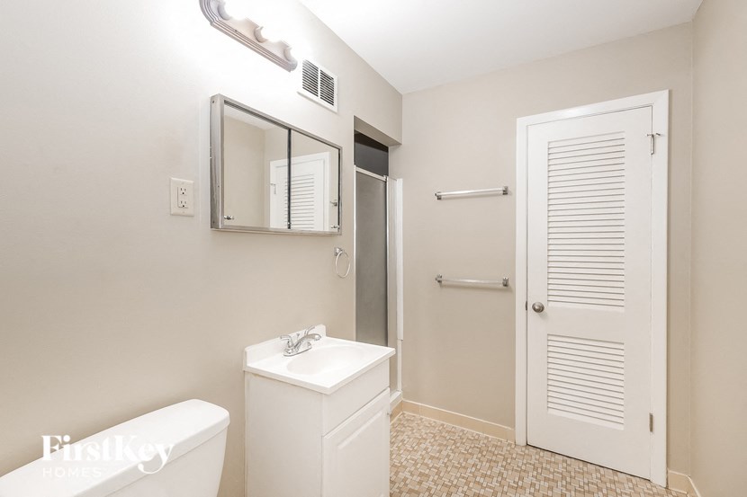 a bathroom with a sink and a mirror and a shower
