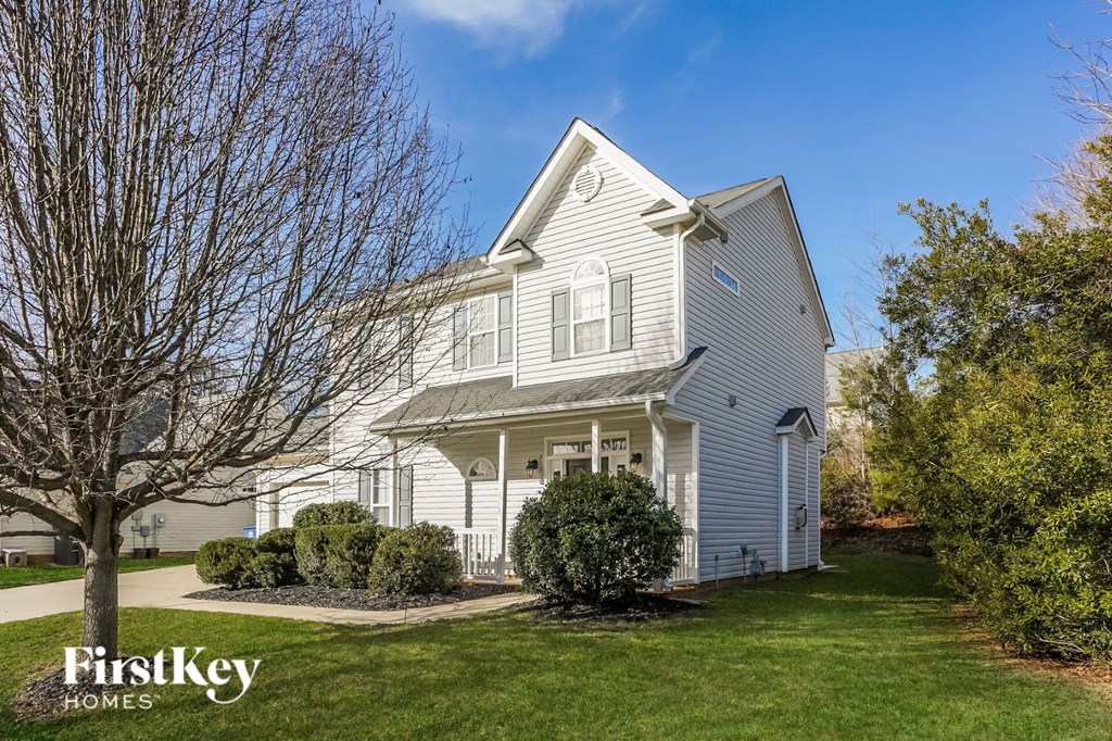 a white house with a yard in front of it