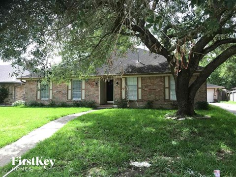 a brick house with a tree in front of it