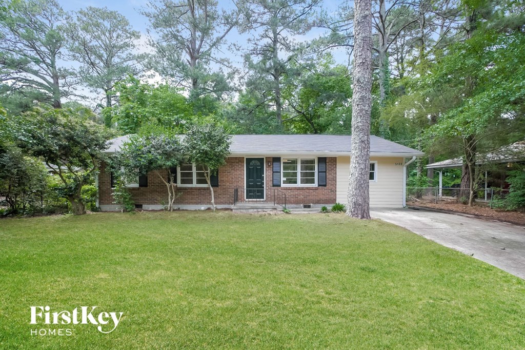 A house with a lawn in front of it.
