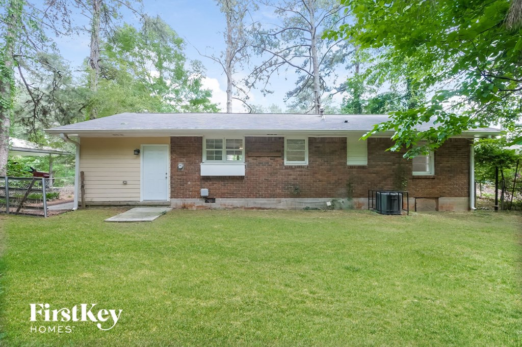 A brick house with a white door and a small porch.