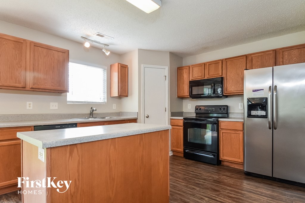 a kitchen with wooden cabinets and stainless steel appliances