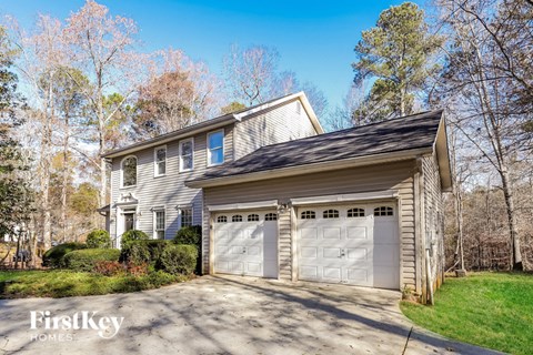 a house with two garage doors on a driveway