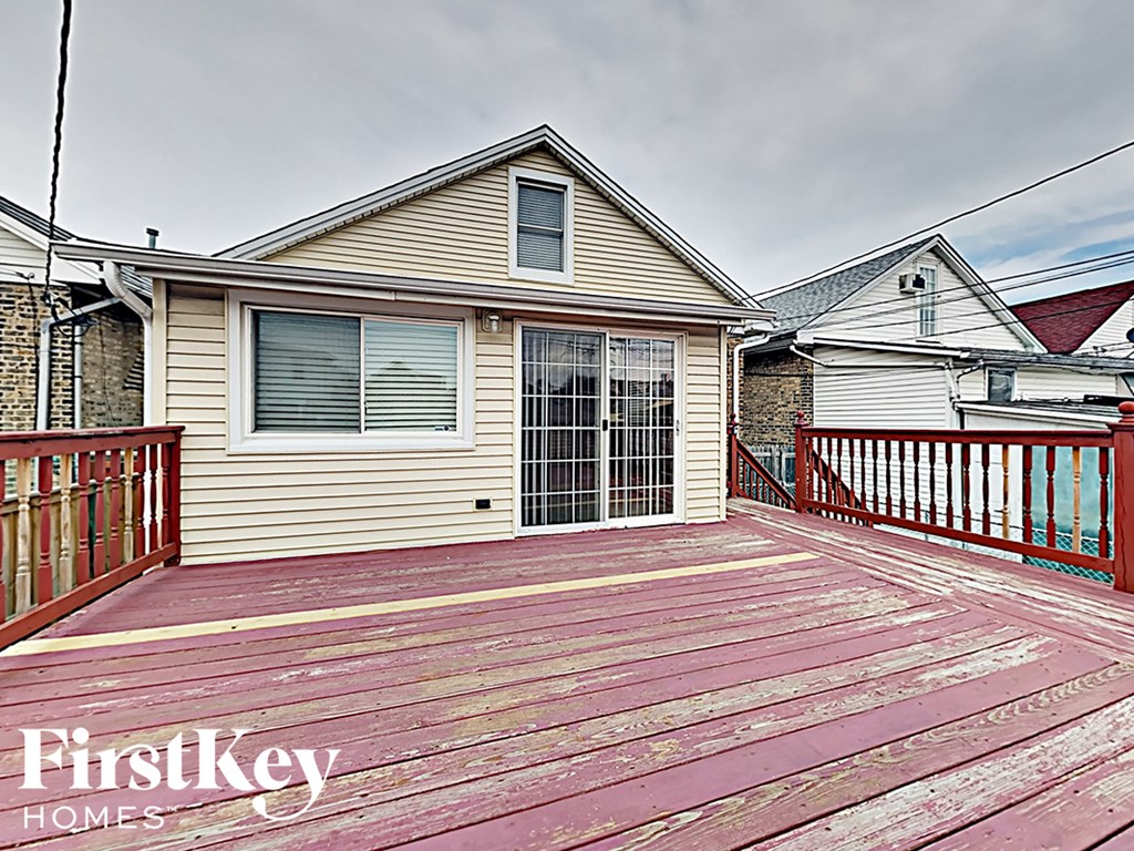 a large deck with a house in the background