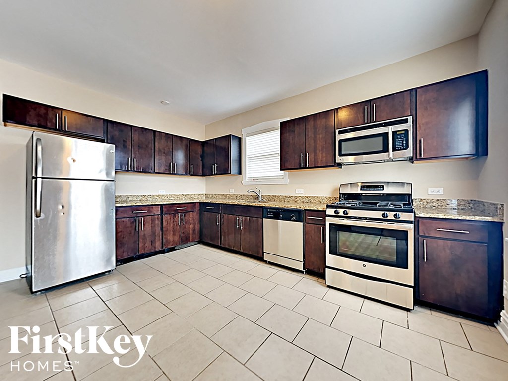 a kitchen with stainless steel appliances and wooden cabinets