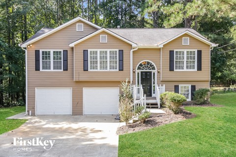 a tan house with a white garage door