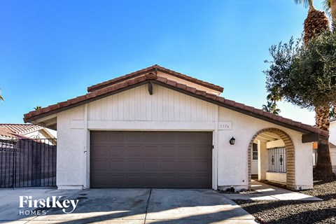 a house with a garage door in front of it