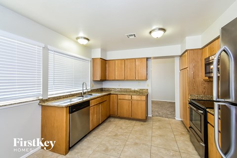 a kitchen with stainless steel appliances and wooden cabinets