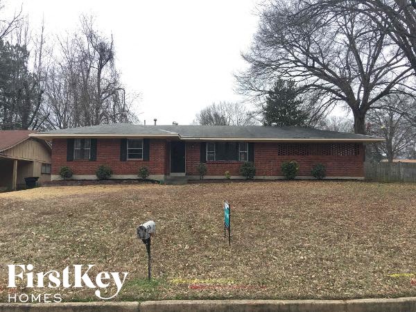 A brick house with a mailbox in front of it.