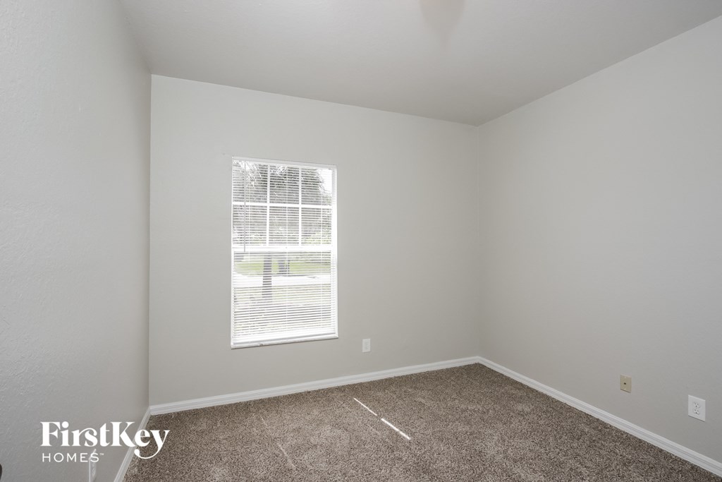 a room with carpet and a window in it