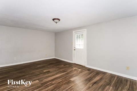 A room with wooden floors and a white door.