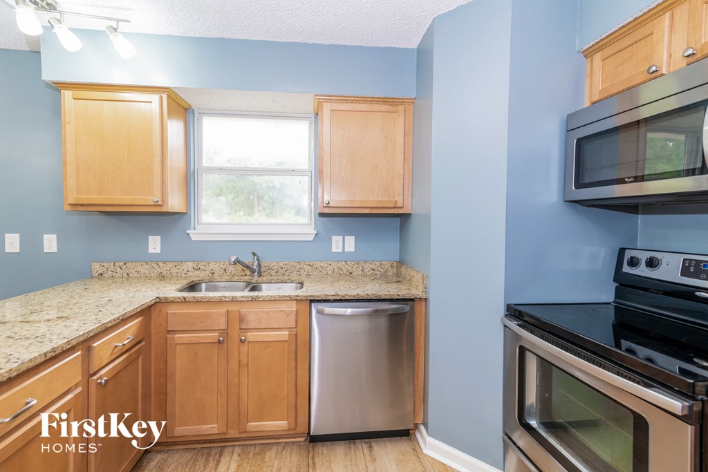 a kitchen with wooden cabinets and stainless steel appliances and a counter top