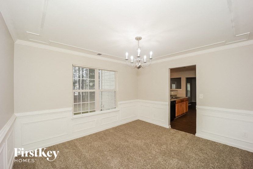 a dining room with a chandelier and a window