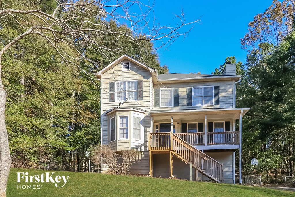 a house with a deck on top of a hill