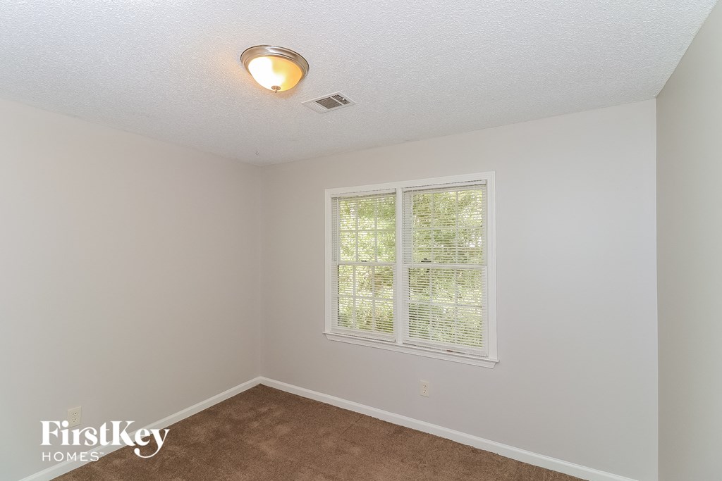 the living room of an empty house with a large window