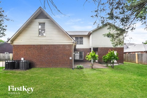 A house with a white and beige exterior is for sale.