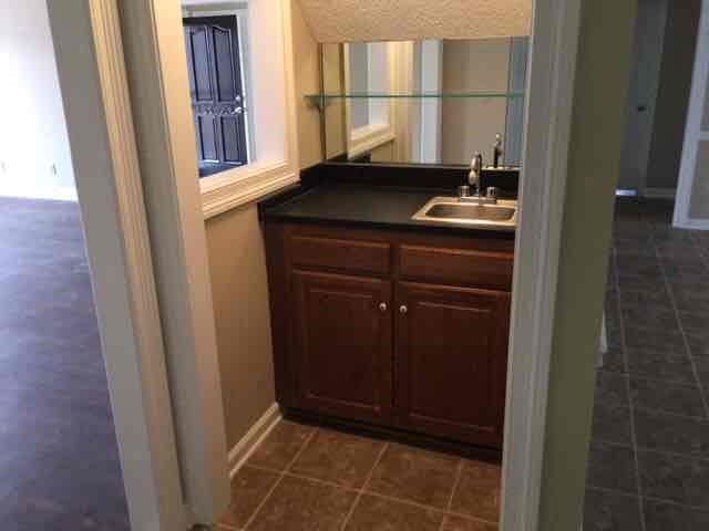 A bathroom with a sink and a cabinet.