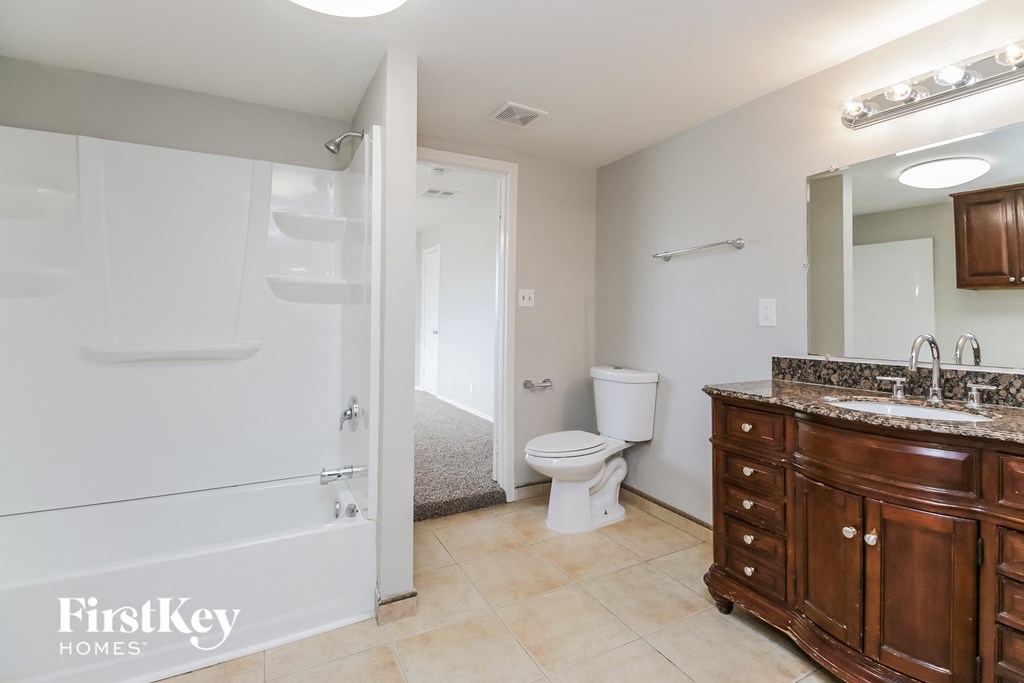 a bathroom with a toilet and a sink and a shower