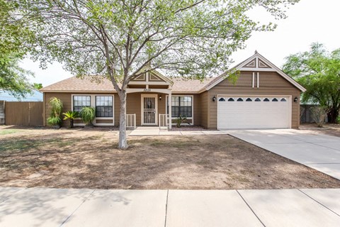 a house with a driveway and a white garage door