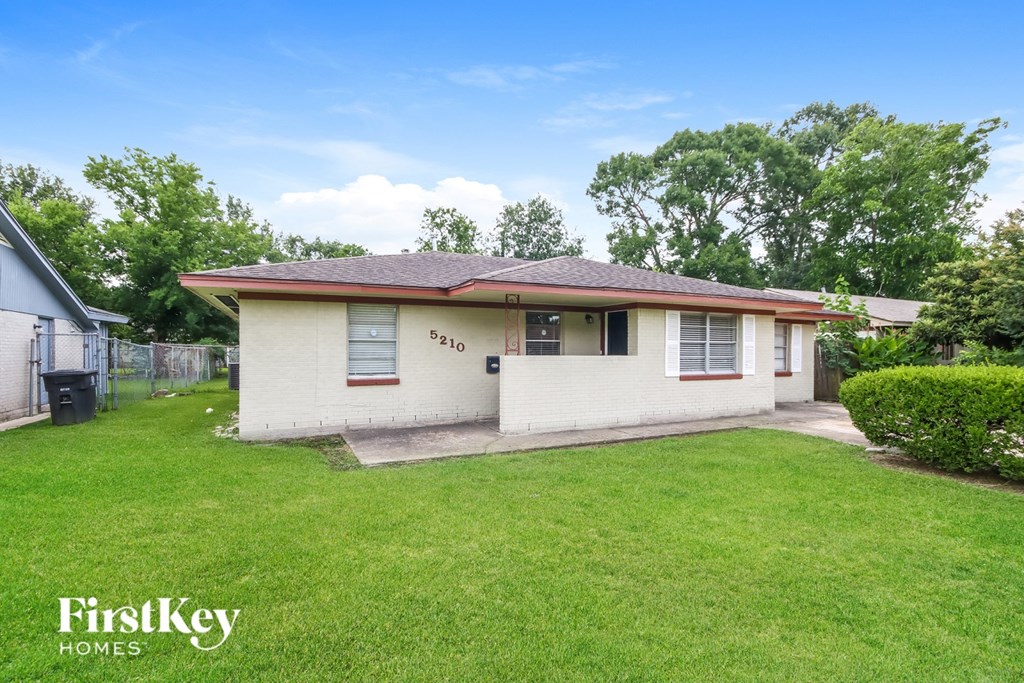 A house with a well-maintained lawn is for sale.