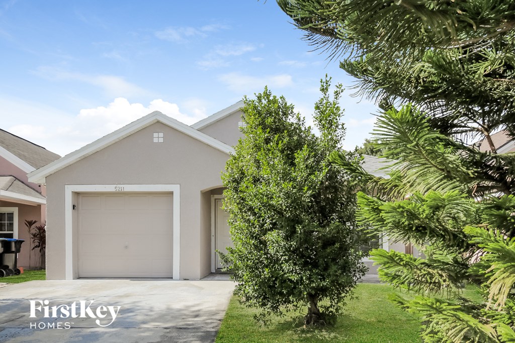 A house with a garage door numbered 621 is for sale.