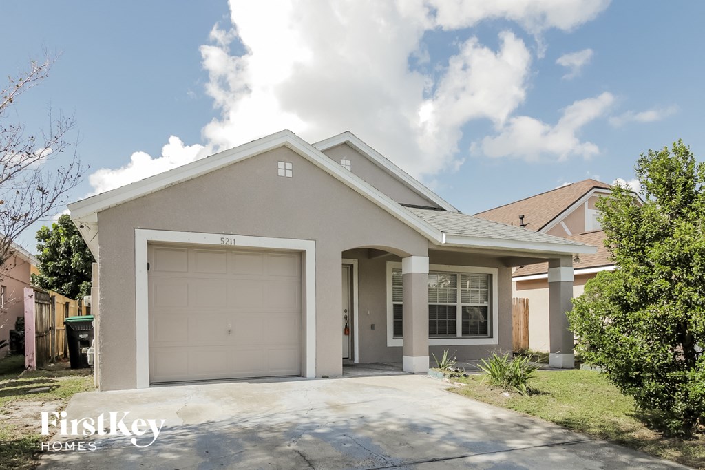 A house with a garage is for sale.