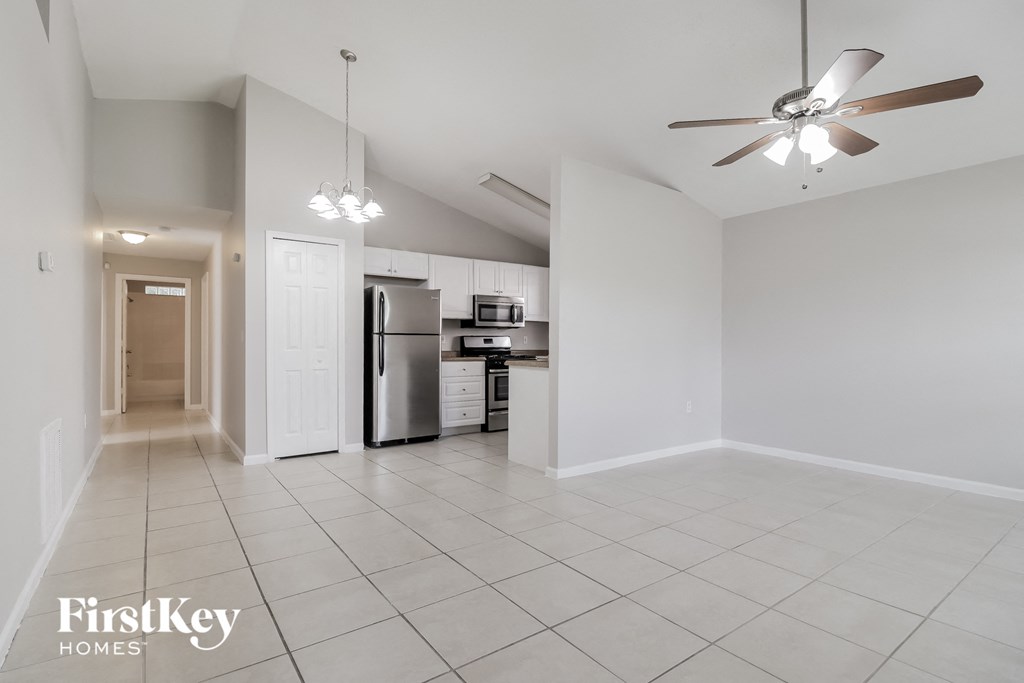 A spacious kitchen with a refrigerator, microwave, and oven.