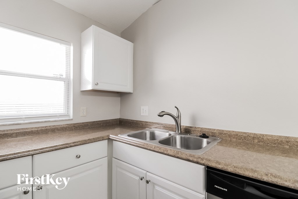 A kitchen with a sink and a window.