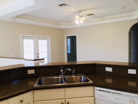 A kitchen with a sink and a dishwasher.
