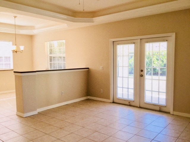 A room with a bar counter and sliding glass doors.